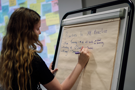 Amelia writing on a flipchart